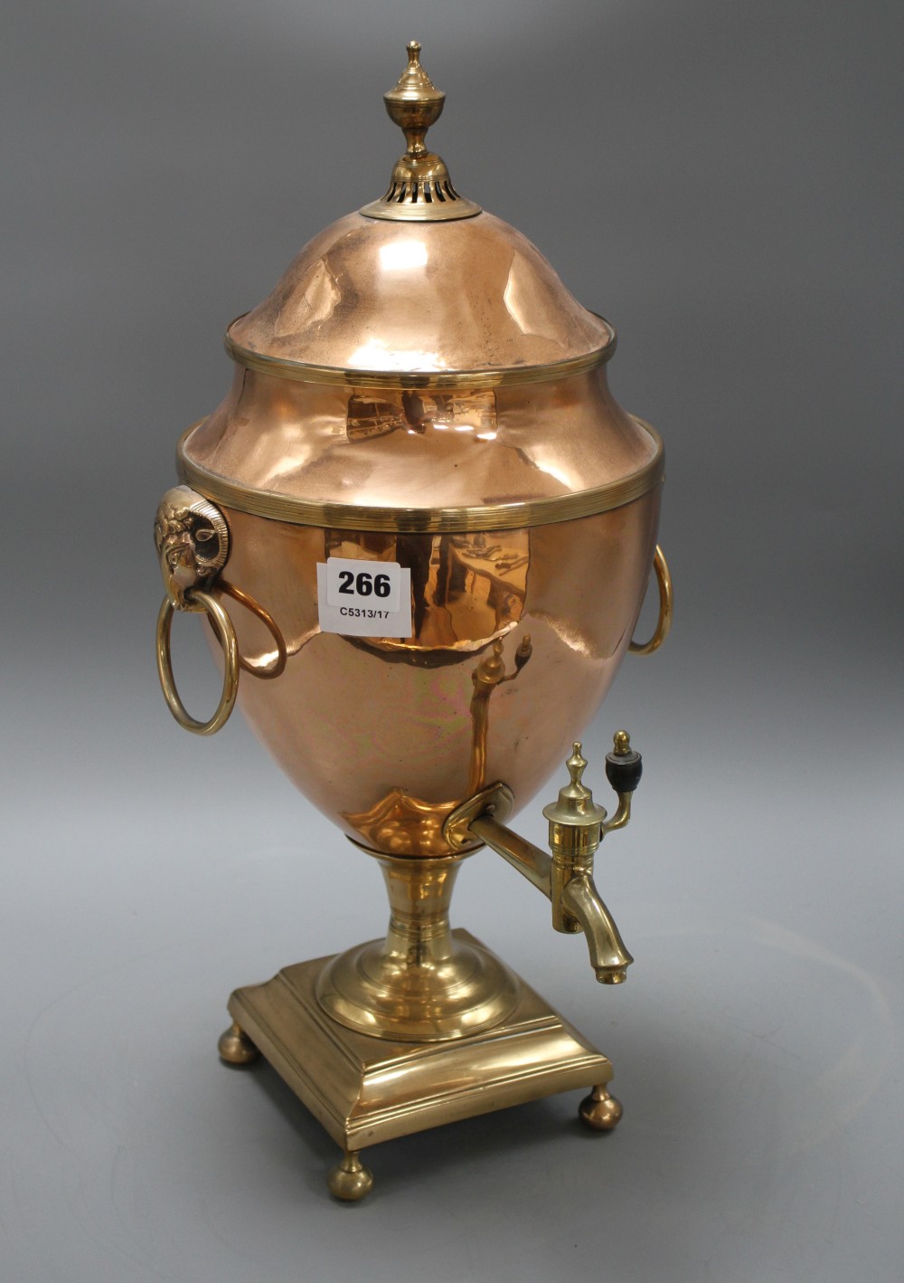 A Regency brass mounted copper tea urn, with rams mask ring handles, height 51cm